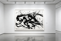 Abstract oil painting with black splashes and drips radiating across white canvas